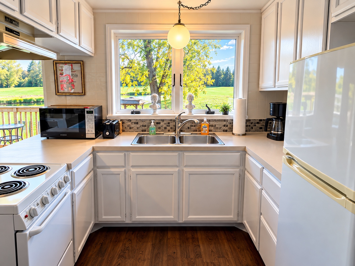 Bright kitchen with white cabinets and a sunlit window